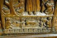 Two monkeys roasting a pig on a spit