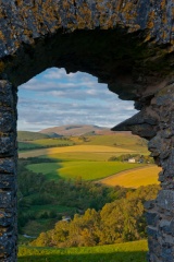 The Fidditch Valley through a window arch