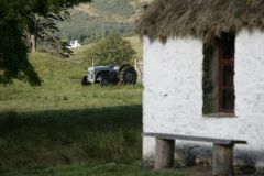 A quiet bench outside a thatched cottage