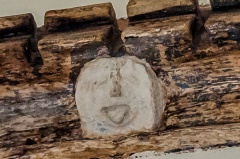 Humourous carved face, chancel frieze