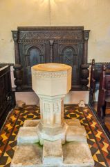 The font and 17th century carved panel