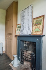 A bedroom fireplace and cupboard