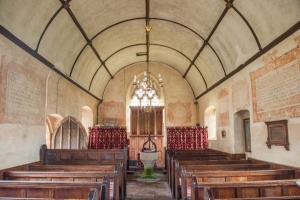 The barrel-vaulted nave and wall texts