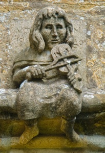 A 'hunky punk' or grotesque, depicting a man playing a fiddle