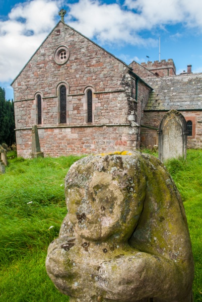A bear statue in front of Dacre church