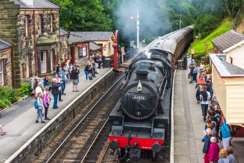 A steam train pulling into in Goathland rail station (Hogsmeade Station)