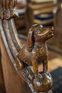 Bench end depicting a dog
