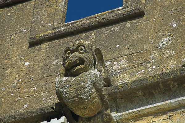 Another carved grotesque. Photo of St Andrew's Church, Chedworth, Gloucestershire.