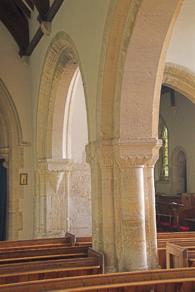 12th century columns between the north aisle and nave. Photo of St Andrew's Church, Chedworth, Gloucestershire.