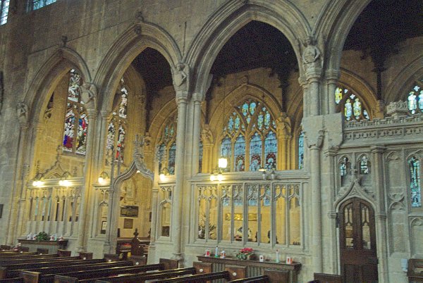 The nave and south aisle. Here you get an idea of the great height of the nave and the beauty of the Perpendicular Gothic pillars. Photo of the Church of St John Baptist, Cirencester, Gloucestershire.