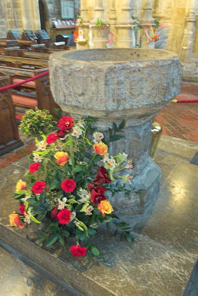 The 15th century font, near the north porch entry to the church. Photo of the Church of St John Baptist, Cirencester, Gloucestershire.