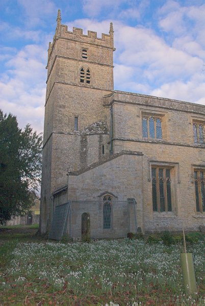 The church and battlemented tower from the churchyard on the south. Photo of St Mary's Church, Great Barrington, Gloucestershire.