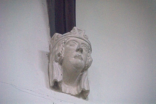 The timber framed roof of the nave is supported on a series of carved corbel heads. Photo of St Mary's Church, Great Barrington, Gloucestershire.