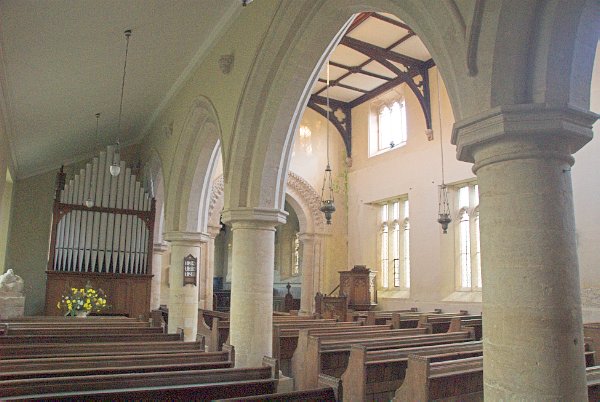 Looking from the north aisle into the nave of St Mary's. Here you get a good view of the beautifully simple rounded pillars. Photo of St Mary's Church, Great Barrington, Gloucestershire.