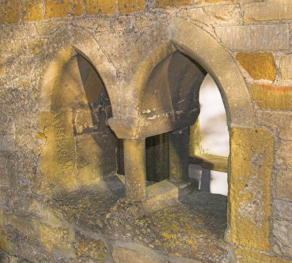 A lovely two-light window in the south porch. Photo of St Mary the Virgin Church, Icomb, Gloucestershire.