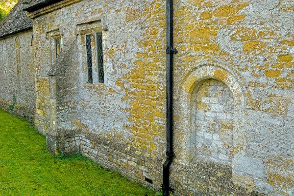 The north wall of the nave. Here you can clearly see the outline of a medieval door, long since filled in. Photo of St Mary the Virgin Church, Icomb, Gloucestershire.