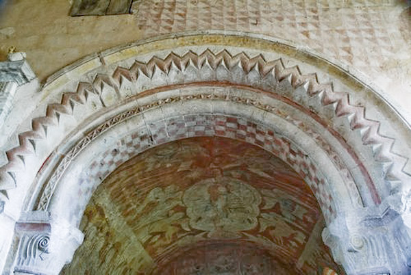 The beautifully decorated chancel arch, showing some of the medieval painting for which Kempley is justly famous. Photo of St Mary's Church, Kempley, Gloucestershire.