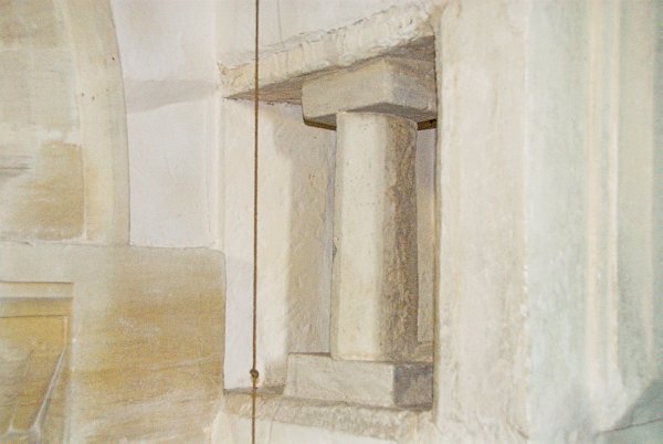 A medieval squint is set into the wall beside the chancel arch, allowing views of the altar from the north aisle. Photo of St Peter's Church, Little Barrington, Gloucestershire. Part of the Britain Express historic picture library.