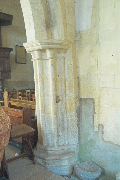 The arches of the nave arcade are lovely examples of 12th century compound pillars. Traces of paint adhere to the curved surfaces of the arches. Photo of St Nicholas' Church, Lower Oddington, Gloucestershire. Part of the Britain Express Historic Picture Library.