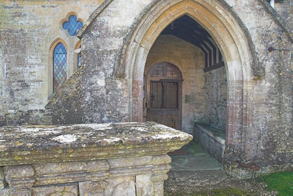 The north porch dates to about 1400. Before the porch stands a 17th century table tomb. Photo of All Saints Church, Salperton, Gloucestershire. Part of the Britain Express Historic Picture Library.
