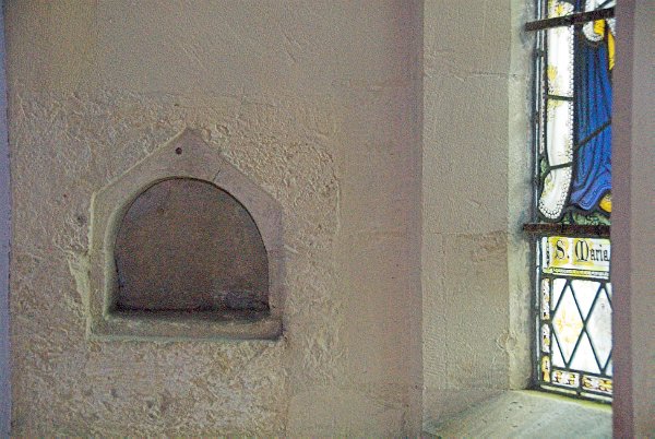 In the Norman sanctuary this small piscina is set into the south wall. Photo of All Saints Church, Salperton, Gloucestershire. Part of the Britain Express Historic Picture Library.