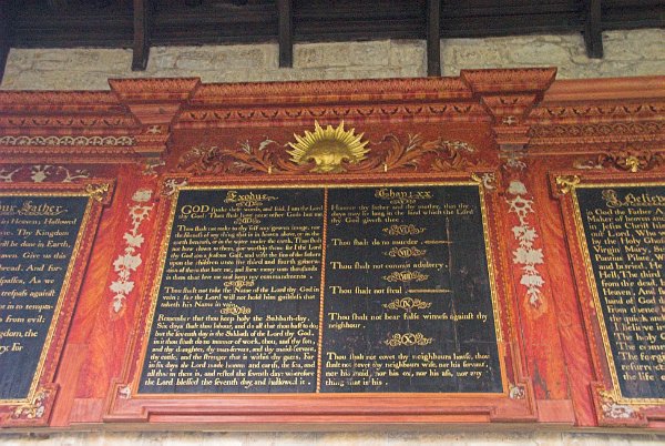 Above the north door is this elaborate 18th century decalogue, of gilded and painted wood. Photo of St Mary's Church, Temple Guiting, Gloucestershire. Part of the Britain Express Historic Picture Library.