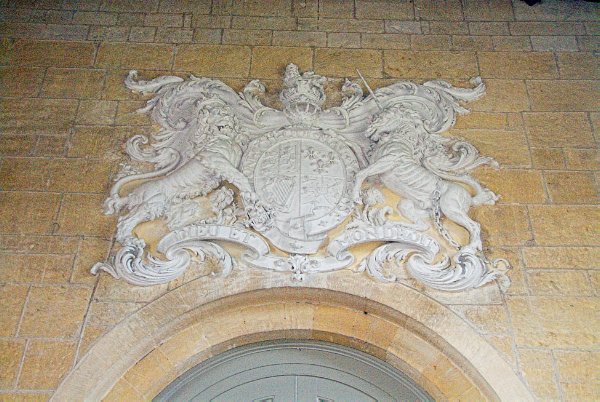 An unusual plaster version of the royal coat of arms over the west door of the nave. Photo of St Mary's Church, Temple Guiting, Gloucestershire. Part of the Britain Express Historic Picture Library.
