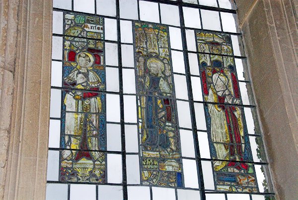 Three panels of late 15th century stained glass in the north wall of the nave. Nine further panels are on display at the Metropolitan Museum of Art in New York. Photo of St Mary's Church, Temple Guiting, in the Gloucestershire Cotswolds. Part of the Britain Express Travel and Heritage Picture Library.