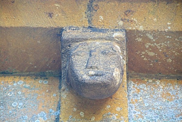 Unlike many 'grotesques' which can look terrifying, or distorted, many of the Temple Guiting figures look very cheerful. Photo of St Mary's Church, Temple Guiting, in the Gloucestershire Cotswolds. Part of the Britain Express Travel and Heritage Picture Library.