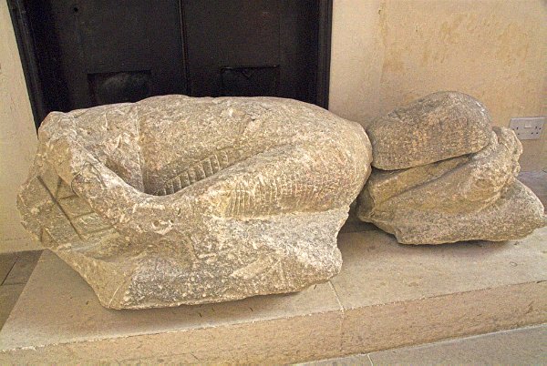 The worn and battered effigy of Sir William de Braose, at the northeast end of the nave. De Braose was a benefactor of Tetbury and the man most responsible for the town's growth in the medieval period. Photo of St Mary's Church, Tetbury, in the Gloucestershire Cotswolds. Part of the Britain Express Travel and Heritage Picture Library.