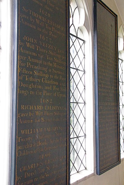 The north ambulatory of the church contains a number of these upright memorial tablets; essentially painted wood signboards commemorating church benefactors. Photo of St Mary the Virgin, Tetbury, Gloucestershire. Part of the Britain Express Historic Picture Library.