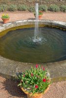 A small fountain stands at the western end of the westernmost canal