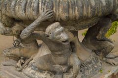 Monkey's upholding a garden urn