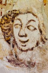 Medieval wall painting of a face
