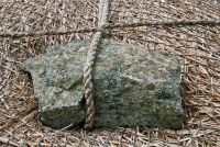 Thatch tie-down stone