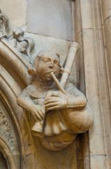 Carving of a bagpipe player