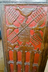 Carved bench end showing a windmill