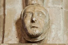 Carved head on nave column