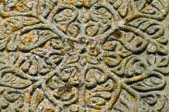 The intricate cross head carving