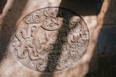 Dryden coat of arms carved on a floor slab