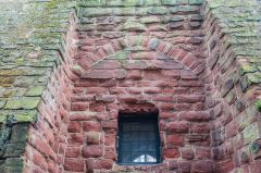 A blocked arch between two buttresses