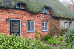 A thatched cottage across from the church