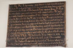 Commemorative plaque over the chapel door