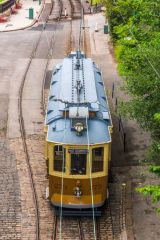 The 1927 Oporto 273 tram passing under the bridge