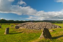 Another view of the standing stones and cairn