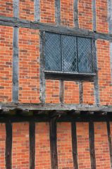 The timber frame exterior infilled with bricks