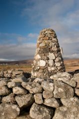 The memorial cairn inside the house ruins
