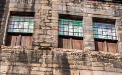 17th century windows with coloured glass and wooden panelled bottoms