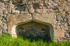 A Tudor fireplace in the south range wall