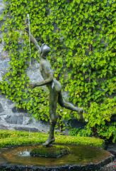 A fountain statue behind the house